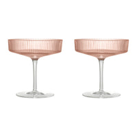 Rose gold champagne coupes with a delicate ribbed pattern and clear glass stems. Perfect for elegant celebrations.