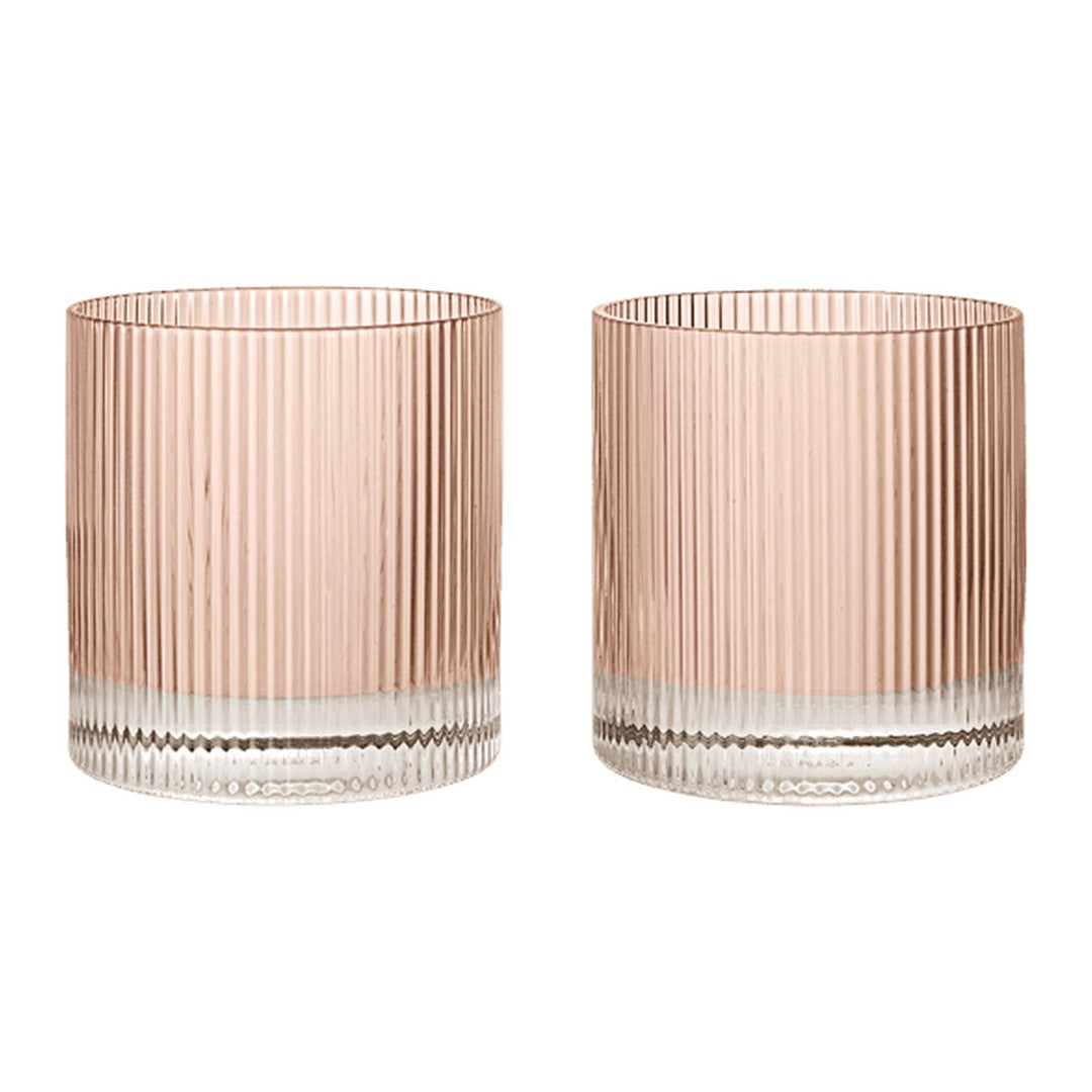 Set of two ribbed glass tumblers in soft pink and clear, featuring vertical striped patterns for a modern look.
