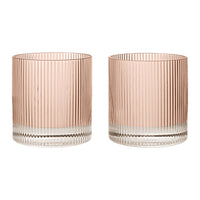 Set of two ribbed glass tumblers in soft pink and clear, featuring vertical striped patterns for a modern look.