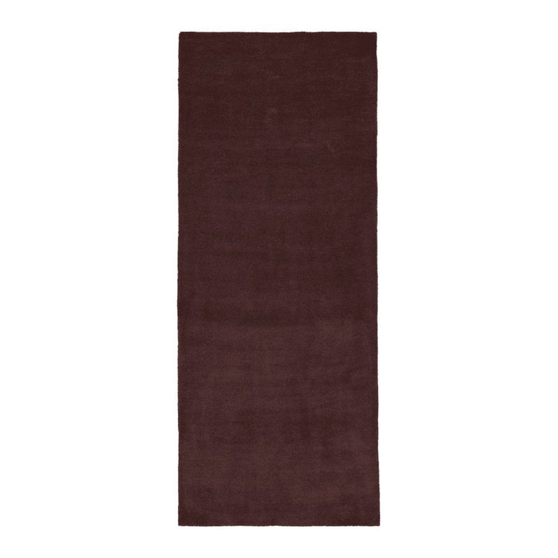 Deep burgundy solid area rug with a soft, textured finish, perfect for adding warmth to any space.