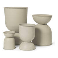 Set of five minimalist neutral beige pots with smooth textures and varied geometric shapes. Perfect for modern decor.