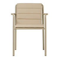 Beige armchair with a sleek, ribbed pattern and minimalist design, featuring a sturdy metal frame.