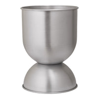 Brushed silver metal egg cup with a smooth, contemporary design and rounded base. Perfect for modern table settings.