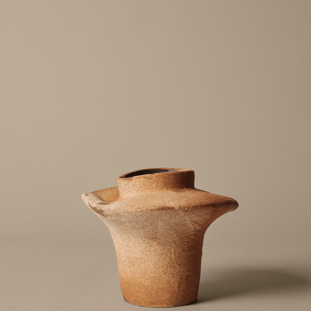 Terracotta vase with a textured finish and natural earthy tones, featuring a unique, organic shape.