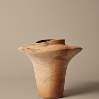 Handcrafted terracotta vase with a smooth, earthy finish and subtle grain patterns in warm brown tones.