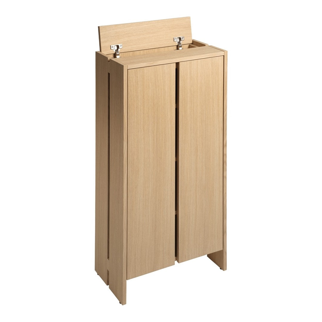 Light oak wooden cabinet with a smooth finish and minimalistic design, featuring two doors and a simple top shelf.