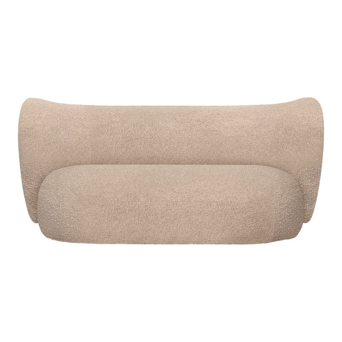 Beige curved sofa in a soft, textured fabric, showcasing a minimalist design and smooth, seamless contours.