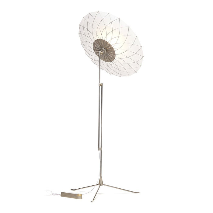 White and beige floor lamp with a floral pattern, featuring a sleek metallic stand and minimalist design elements.