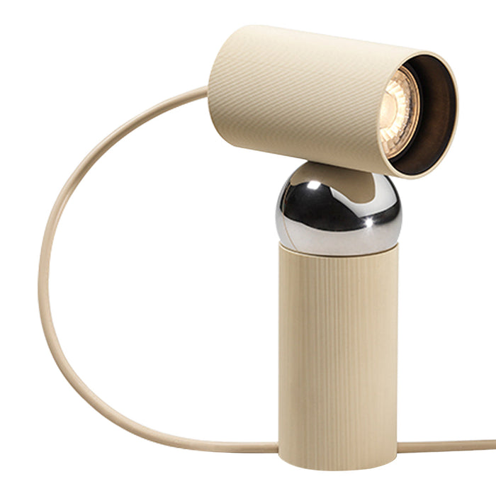 Beige lamp with a textured finish and a shiny chrome base, featuring a modern, minimalist design.