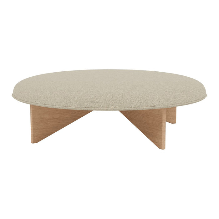Round coffee table with a soft beige top and natural wood legs, featuring a minimalist design. Ideal for modern decor.