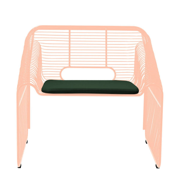 Peach wireframe armchair with a solid green cushion, featuring a minimalist design and open patterns.