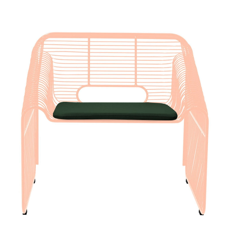 Peach wireframe armchair with a solid green cushion, featuring a minimalist design and open patterns.