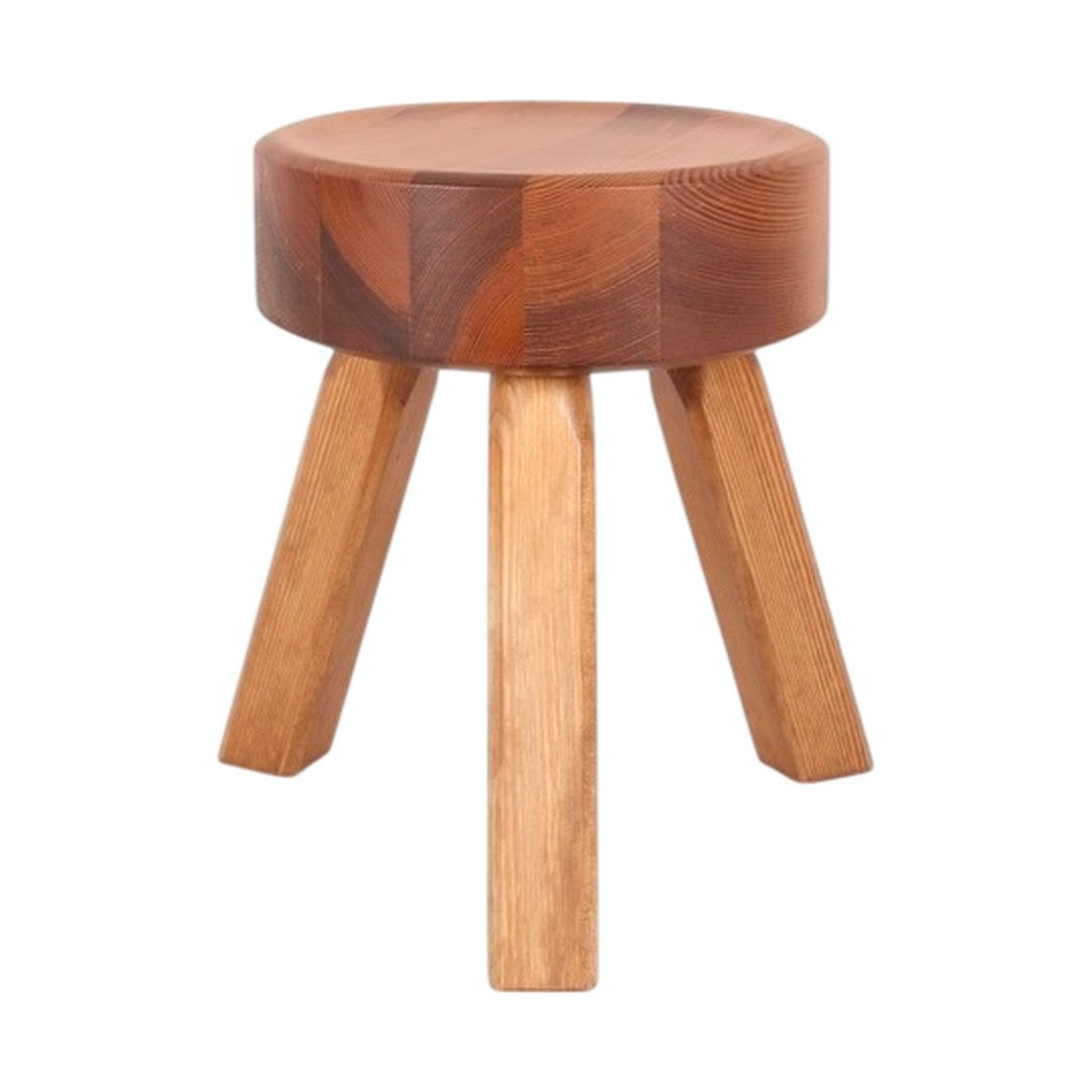 Round wooden stool with a warm brown top and light wooden legs, showcasing smooth, natural patterns.