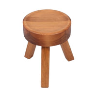Round wooden stool in natural brown finish with a smooth top and three tapered legs. Perfect for any decor style.