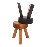 Two-tone wooden stool featuring a dark brown top and light brown base with simple, modern design.