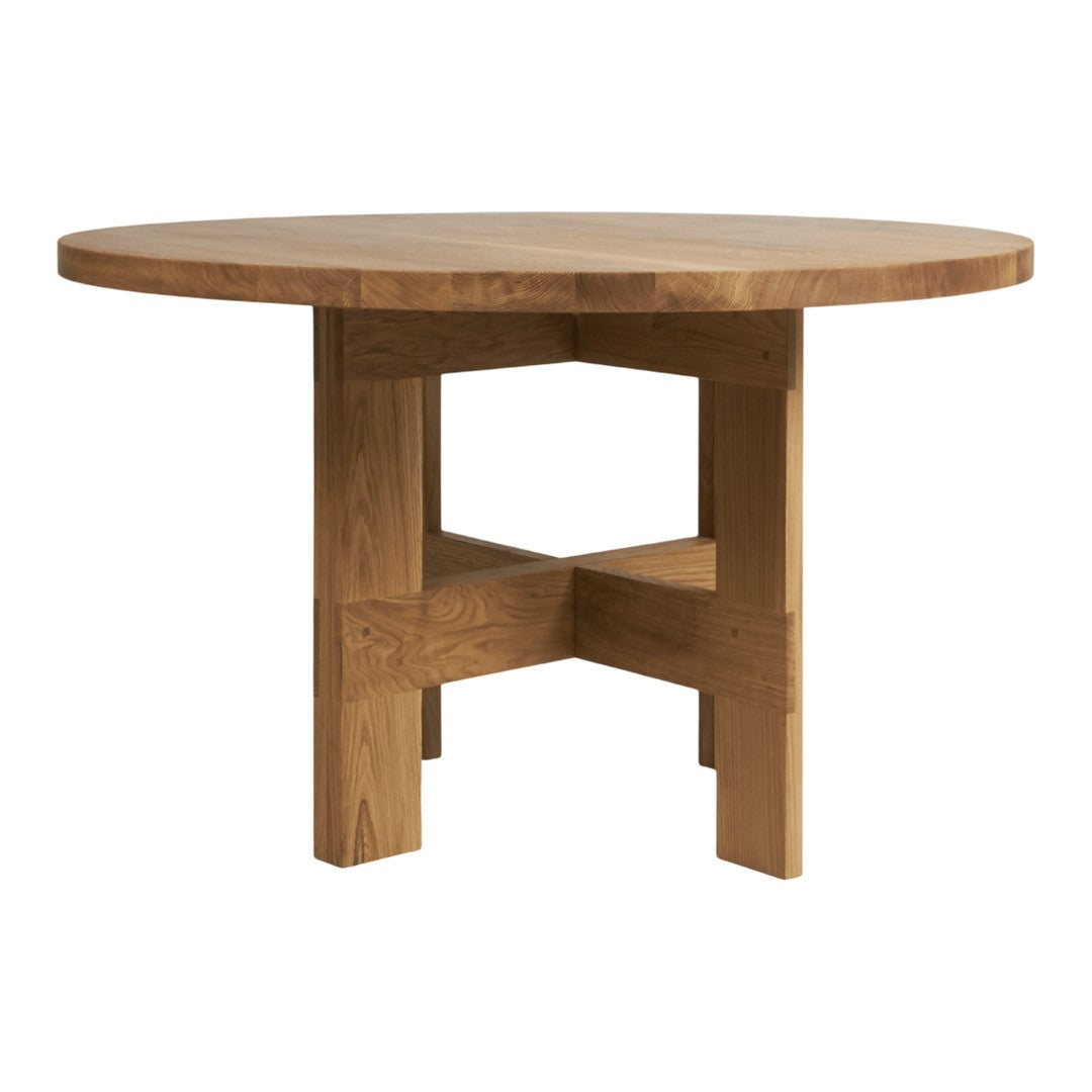 Round wooden table in a warm oak finish with a smooth surface and simple, modern design.