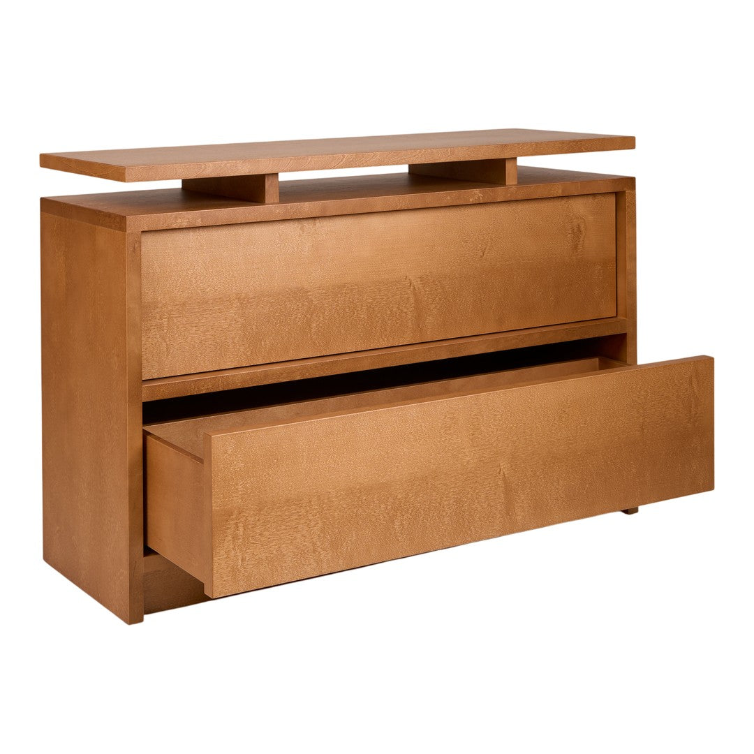 Light brown wood dresser with a smooth surface, featuring clean lines and an elegant, minimalist design.