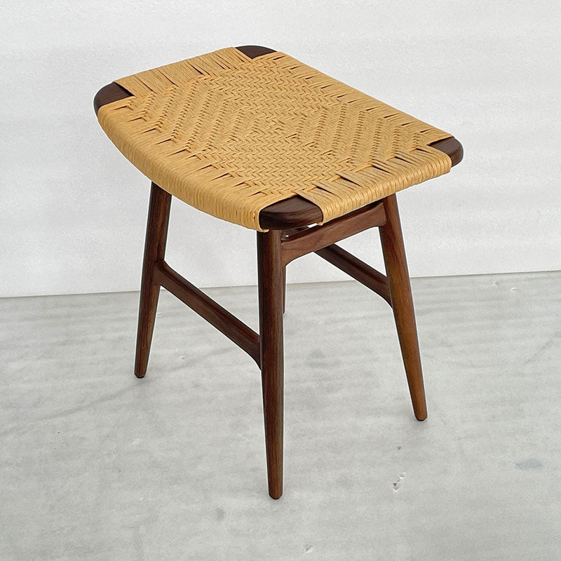 Woven natural straw top with rich brown wooden legs, featuring a geometric pattern and elegant design.