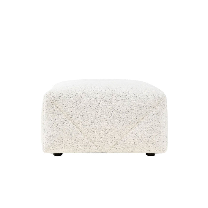 Textured white ottoman with subtle detailing, perfect for modern decor. Ideal accent for any living space.