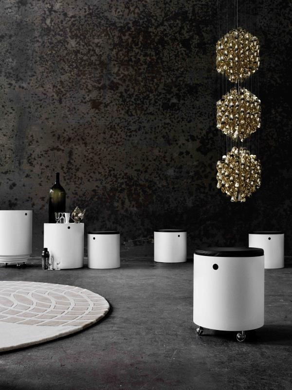 Modern white storage bins with black tops, featuring soft geometric patterns in a stylish, dark industrial setting.