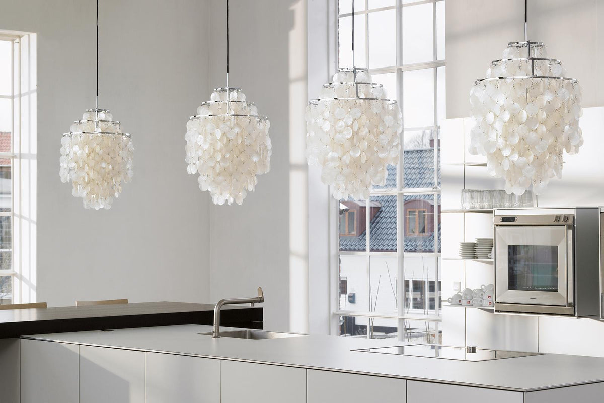White pendant lights with a unique layered petal pattern, adding elegance to a modern kitchen interior.