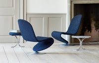 Navy blue chairs with a speckled pattern and silver bases, set on a light wooden floor.