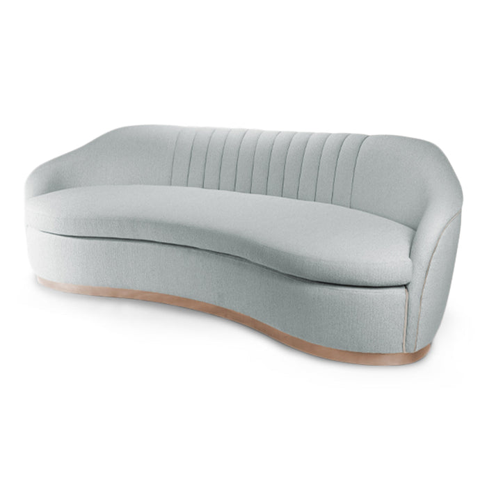 Curved light gray sofa with plush upholstery and subtle ribbed pattern, featuring a sleek wooden base.