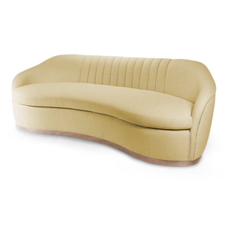 Curved yellow sofa with vertical stitching and wood trim accents, perfect for modern decor.