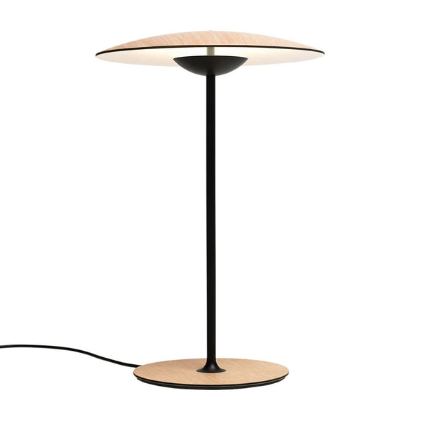 Modern black and wood table lamp with a sleek circular shade, featuring a minimalist design and warm tones.
