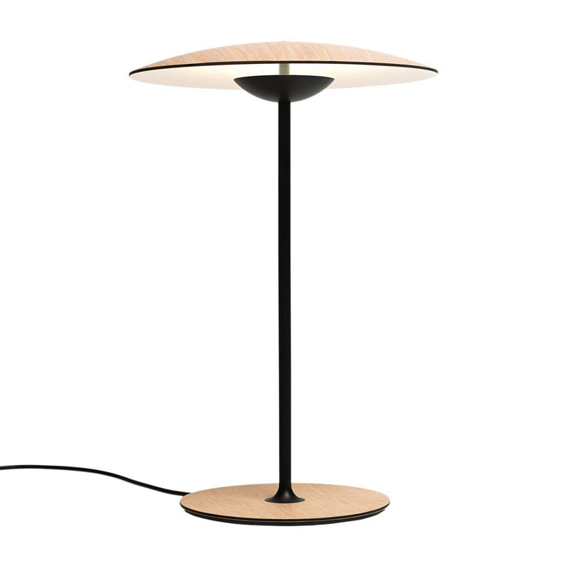 Modern black and wood table lamp with a sleek circular shade, featuring a minimalist design and warm tones.