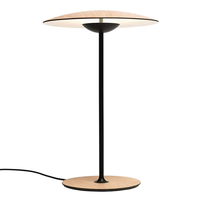 Modern lamp with a black base and stem, featuring a beige, round shade for a sleek, minimalist design.