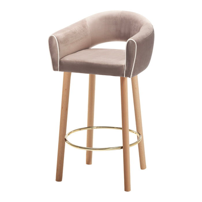 Sleek beige velvet bar stool with white piping and natural wood legs, featuring a gold footrest for a modern touch.