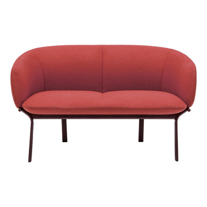 Rust-colored modern sofa with a smooth, curved design and sleek metal legs, ideal for contemporary living spaces.