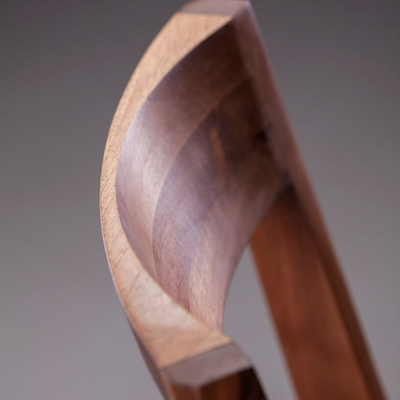 Curved wooden design showcasing rich brown tones with smooth, polished texture. Perfect for modern decor.