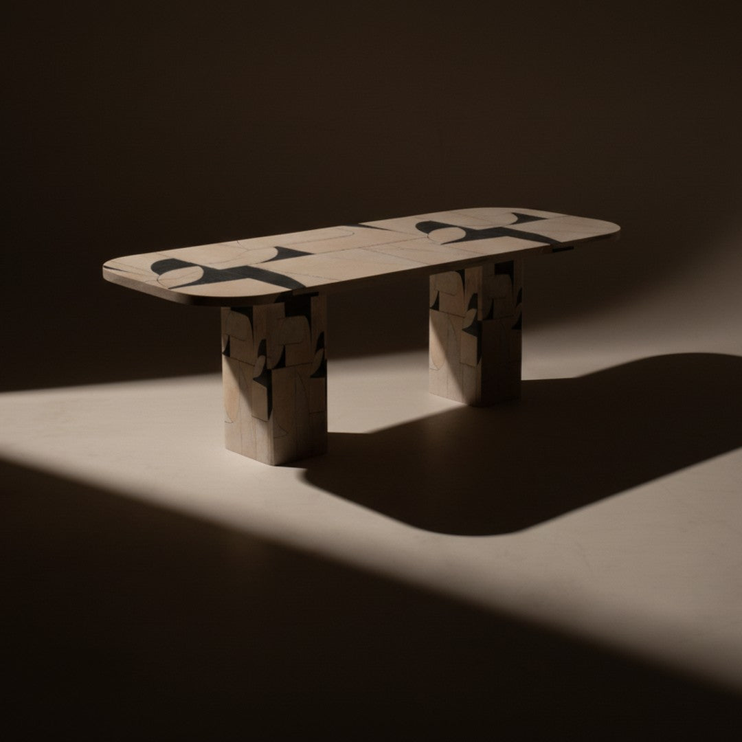 Stylish beige table with abstract black patterns on the top and unique geometric bases in a minimalist design.