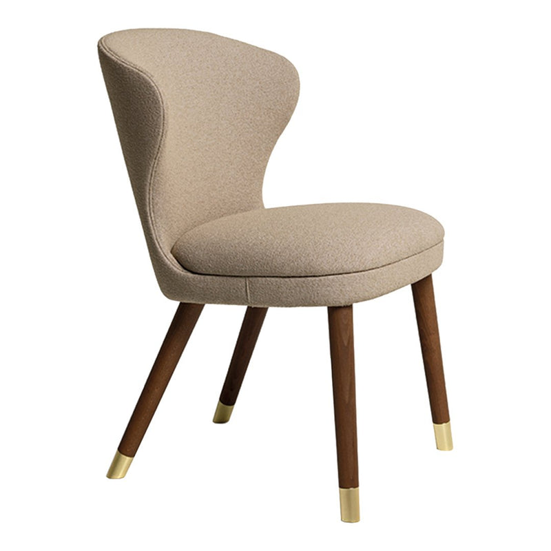 Beige upholstered chair with a curved back and walnut legs featuring gold accents. Elegant and modern design.