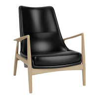 Black leather armchair with a light wood frame, featuring sleek lines and a modern, minimalist design.