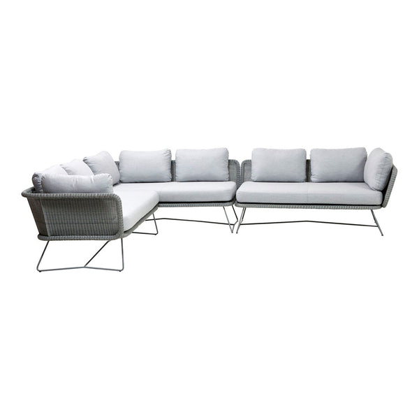 Modern gray sectional sofa with plush white cushions and sleek metal legs, perfect for contemporary outdoor settings.