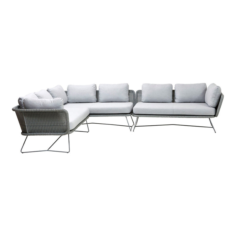 Modern gray sectional sofa with plush white cushions and sleek metal legs, perfect for contemporary outdoor settings.