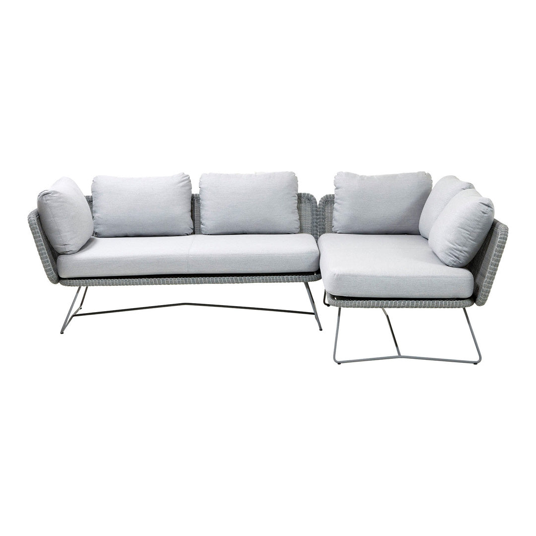Light gray sectional sofa with plush cushions and a sleek metal frame, perfect for modern living spaces.