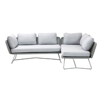 Light gray sectional sofa with plush cushions and a sleek metal frame, perfect for modern living spaces.