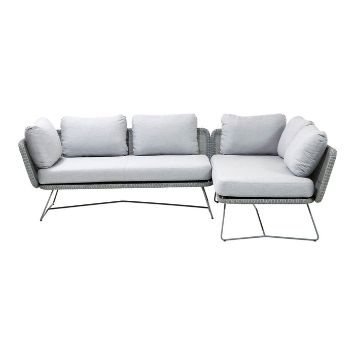 Light gray sectional sofa with plush cushions and a sleek metal frame, perfect for modern living spaces.
