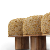 Stylish textured upholstery in natural beige with golden speckles, paired with sleek wooden bases.