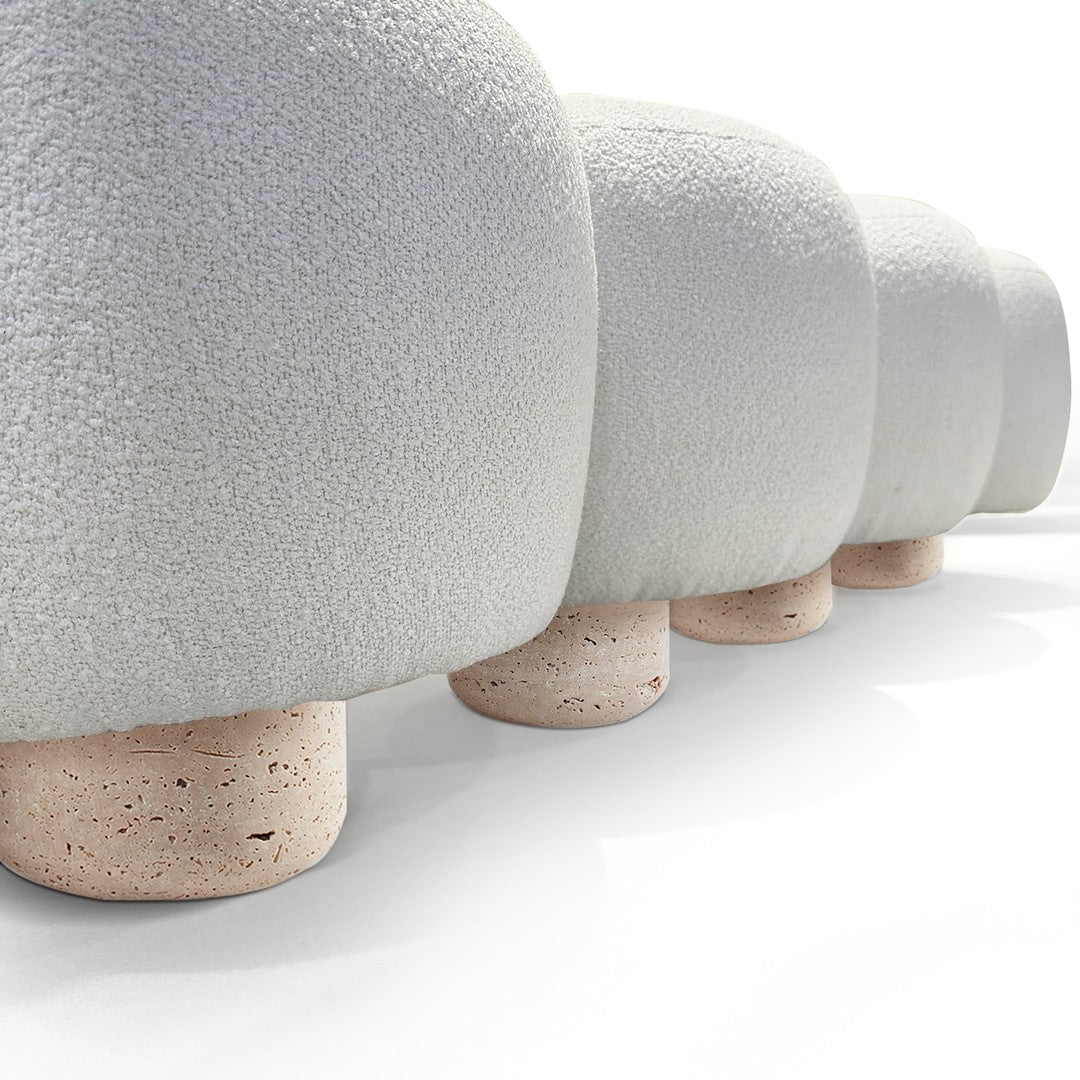 Soft gray plush upholstered mushrooms with textured tops and light beige stone bases, arranged in a row.