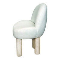 Curved chair in pale mint fabric with textured pattern, featuring light-colored rounded legs. Perfect for modern decor.