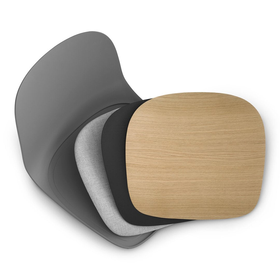 Stacked seating cushions in gray, black, and light wood grain with smooth, modern contours.