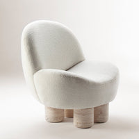 Soft white boucle upholstery with rounded silhouette and light stone-colored legs, creating a modern, minimalist look.
