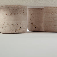 Light pink textured concrete pots with subtle earthy flecks, showcasing a modern and minimalist aesthetic.