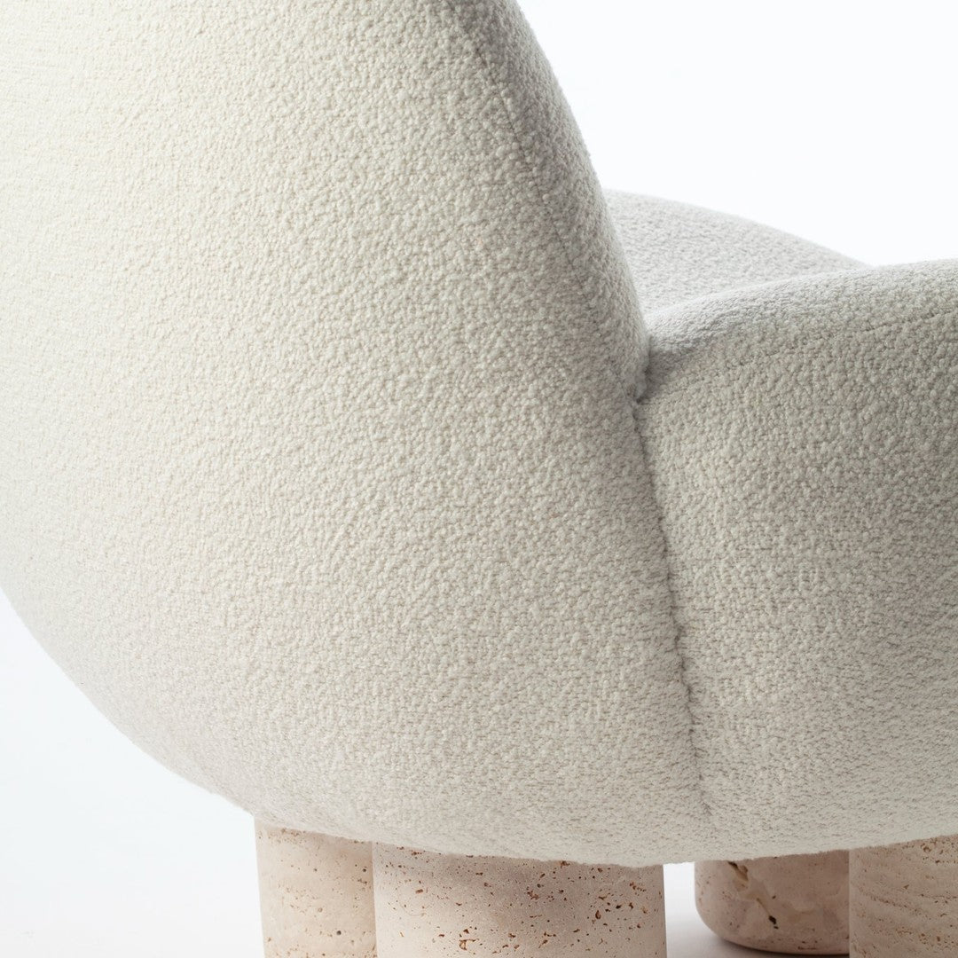 Textured off-white fabric with soft, rounded shape and light-colored speckled legs. Elegant and modern design.