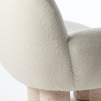 Textured off-white fabric with soft, rounded shape and light-colored speckled legs. Elegant and modern design.